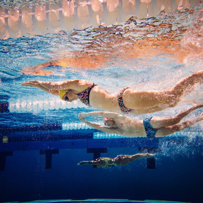 Swimmers doing freestyle in lane